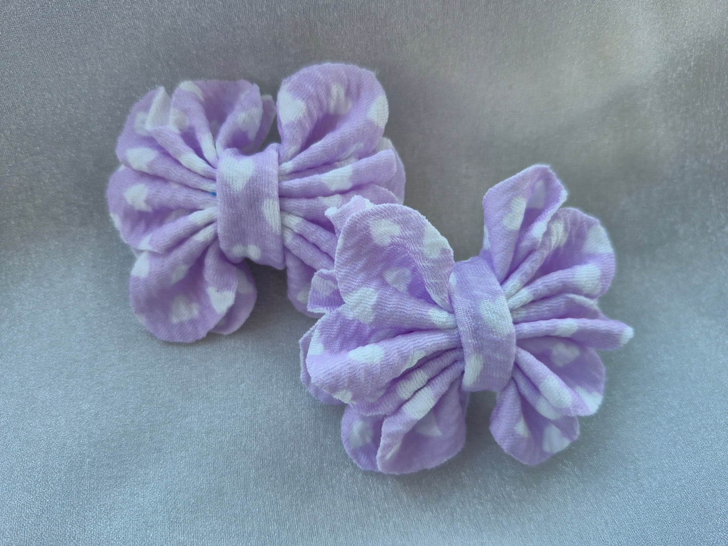Lilac colored, pigtail bows