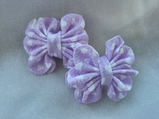 Lilac colored, pigtail bows